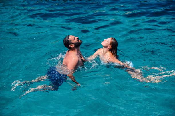 istock Couple having fun in the sea 1618148379