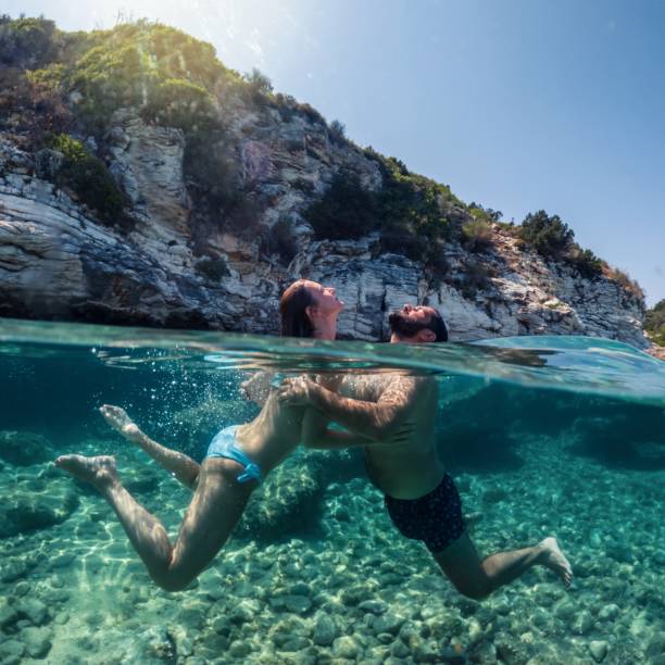 istock Couple having fun in the sea 1618154729
