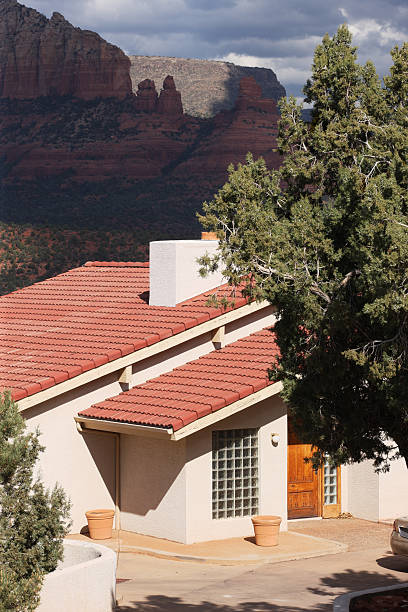 Luxury Home Courtyard Entrance Facade Southwest luxury home with desert wilderness butte and storm sky in the background.  Sedona, Arizona, 2013. nook architecture photos stock pictures, royalty-free photos & images
