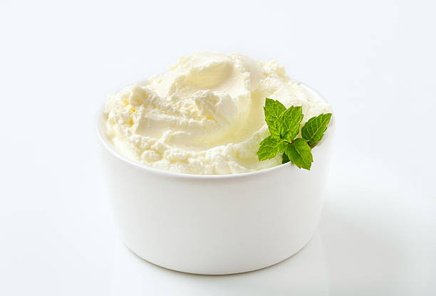 sweet cream cheese in a bowl sweet soft cream cheese with a mint in a small white bowl curd cheese stock pictures, royalty-free photos & images