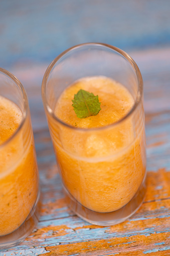 Delicious Bowl of tasty melon sorbet, melon and mint leaf verrine, High quality photo