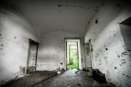 old decaying building with broken windows, close view