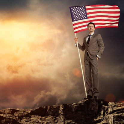 Businessman holding an american flag
