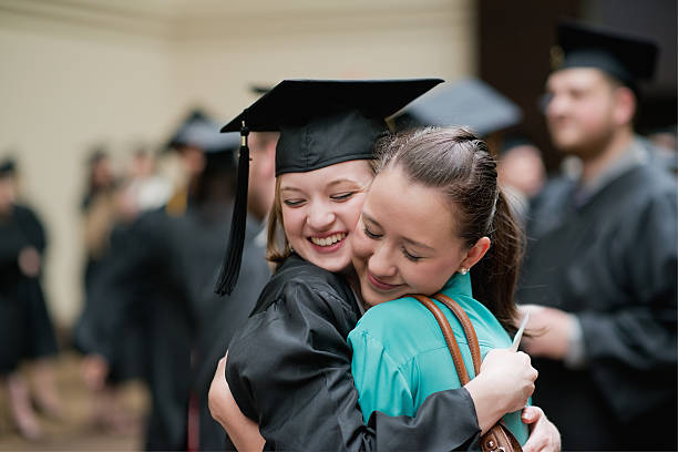 istock Young woman graduate hugging her friend 161818939