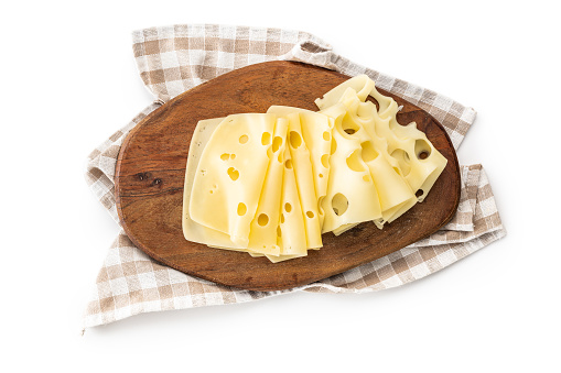 Slices of cheese on cuttinfg board isolated on the white background.