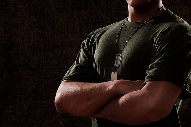 US Marine Corps Solider Dark US Marine Corps Solider in olive green undershirt and dog tags. us marine corps stock pictures, royalty-free photos & images