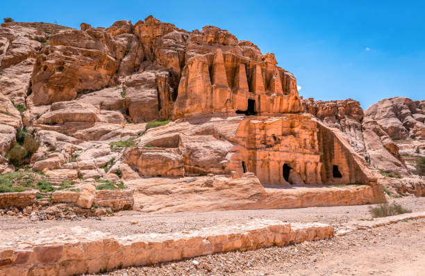 la carretera principal a petra, la antigua ciudad nabatea en jordania, con hilera de tumbas monumentales talladas - petra antiquities jordan middle east fotografías e imágenes de stock