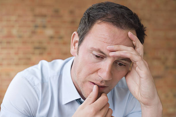 istock Stressed Businessman With Head In Hands 161821496