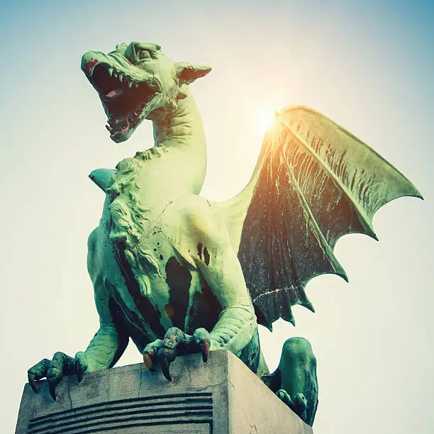Dragon on a stone pillar of famous Dragon Bridge, Zmajski Most, in Ljubljana, Slovenias capital city. Ljubljana, Slovenia.