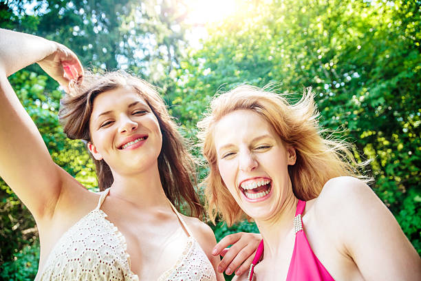 Two Girls enjoying their Summer Vacation Outdoors. Real people portrait, summer fun snapshot.