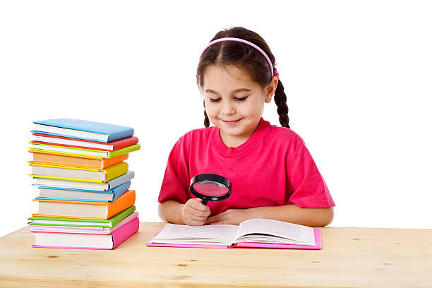 istock Smiling girl with books and magnifier 161822224