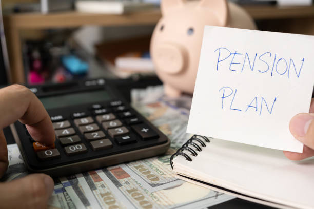 istock Paper note with text PENSION PLAN with stationery on desk. Pension Plan. Retirement concept. Pension calculation concept. copy space for text. Piggy bank. 1618229348
