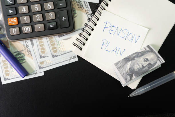 istock Paper note with text PENSION PLAN with stationery and dollar on desk. Pension Plan. Retirement concept. Pension calculation concept. 1618229915