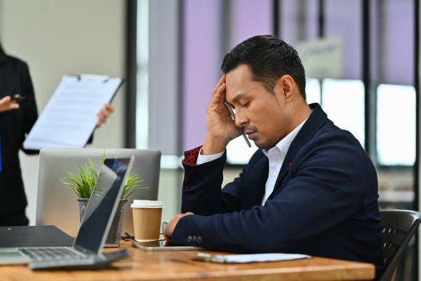 istock Exhausted millennial male worker feeling stressed or suffering from head ache during a meeting in the office 1618234247