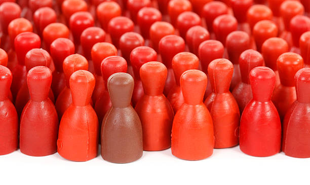 istock Only one in crowd is brown all others are red 161823820