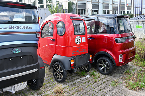 Korschenbroich, Germany, August 9, 2023 - Chinese electric micro cars and cabin scooters (e.g. LinLong) up to 45 km/h on display at a dealer in Korschenbroich