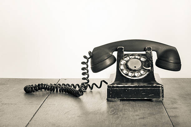 Vintage telephone on a wooden table stock photo