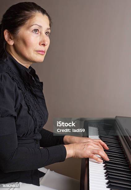 Woman Playing Piano Stock Photo - Download Image Now - 30-39 Years, 50-54 Years, Activity