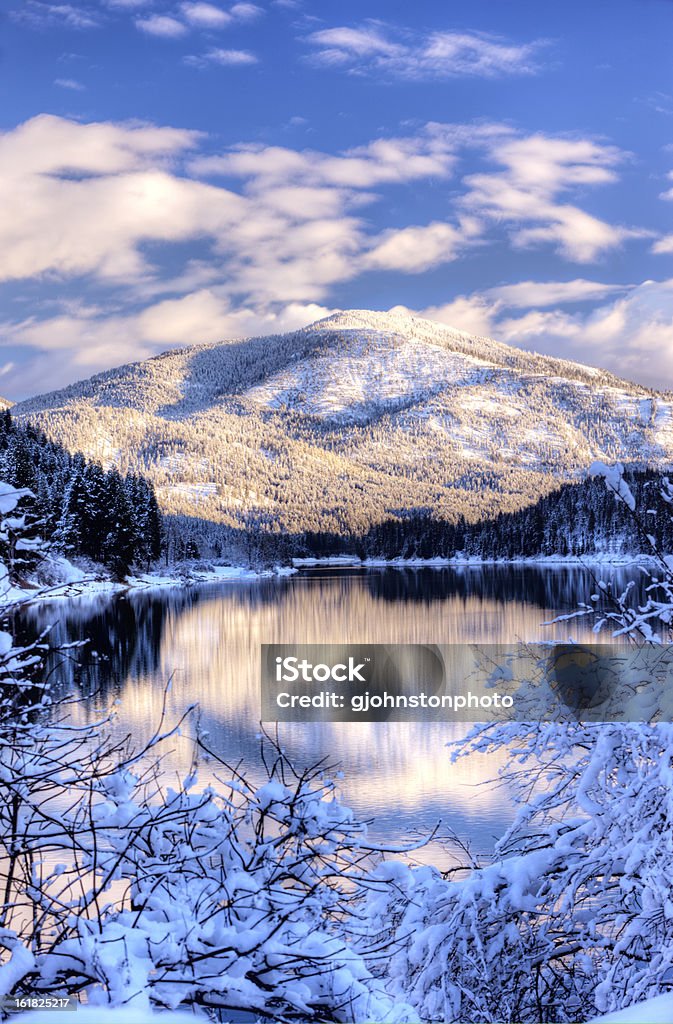 Snowy mountain and river. The reflection of a snow covered mountain on the Pend Oreille River in Eastern Washington. Winter Stock Photo