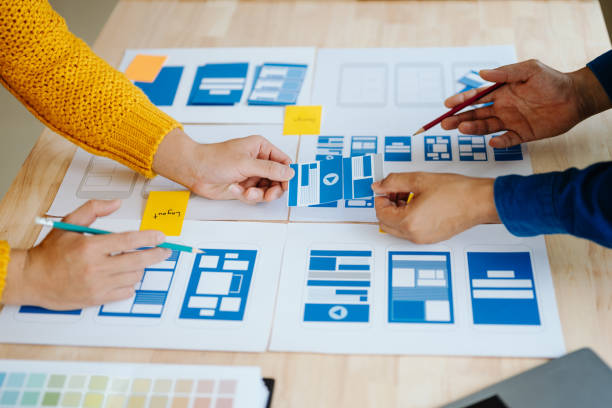 istock Close up view of UI developer team brainstorming on their project with laptop, smartphone and digital tablet. Creative digital development agency. in office 1618259914