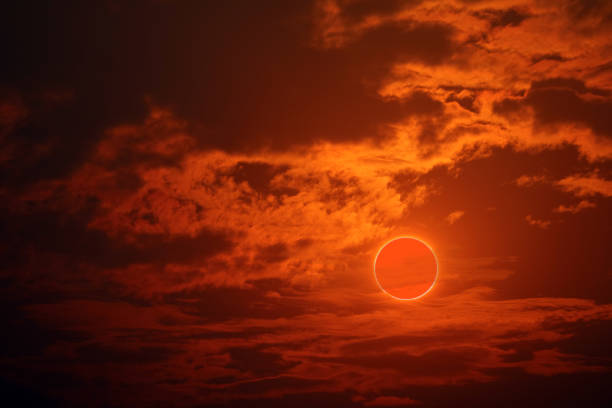 istock eclipse on the orange of sunset sky and soft cloud 1618264361