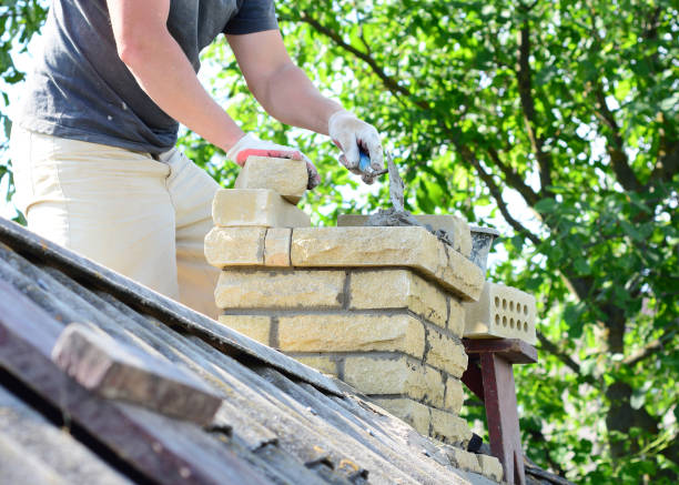 istock Bricklayer repair brick chimney on asbestos house rooftop close up 1618266112