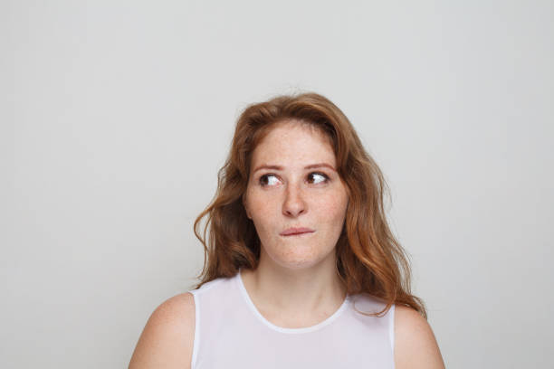 istock Thinking woman on white background. Doubt and idea concept 1618267282