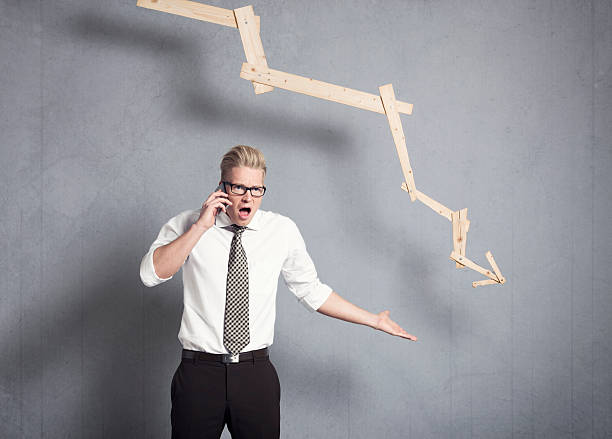 istock Angry businessman in front of graph pointing down. 161826732