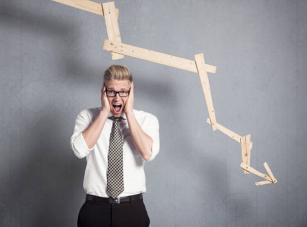 istock Devastated businessman shouting in front of graph pointing down. 161826780
