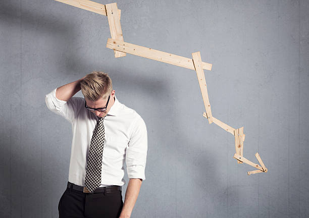 istock Disappointed businessman in front of graph pointing down. 161826783