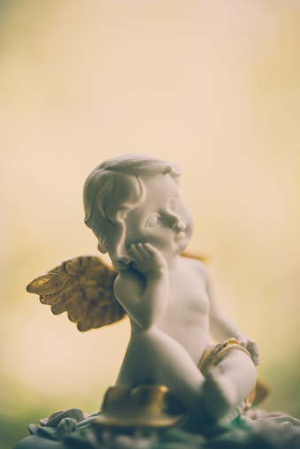 Cute angelic cupid statue. Valentine day, love, romance concept.