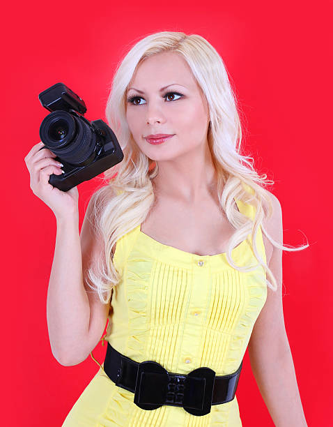 istock beautiful blonde photographer with professional camera over red 161827599
