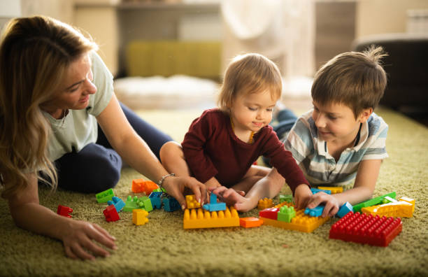 istock Mother playing whit her children at home 1618282355