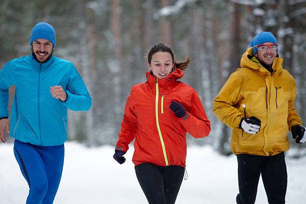 istock Group of young people running in winter 161828748
