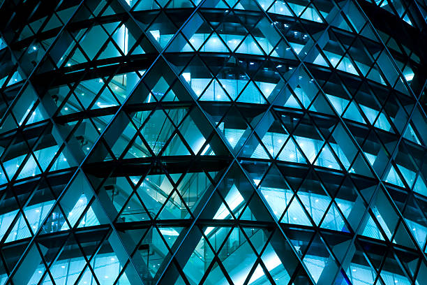 Modern Office Building Illuminated at Night futuristic office building at night, blue toned image, Canon EOS 1Ds Mark III, RAW 16 bit, Adobe RGB midsection photos stock pictures, royalty-free photos & images