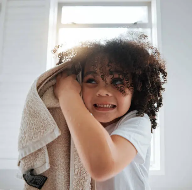 Bathroom, towel or child washing hair in shower in daily morning grooming routine at home. Biracial kid, natural or young boy cleaning for wellness, hydration or healthy haircare with afro hairstyle