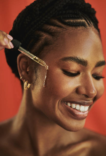 istock woman applying face serum 1618298241