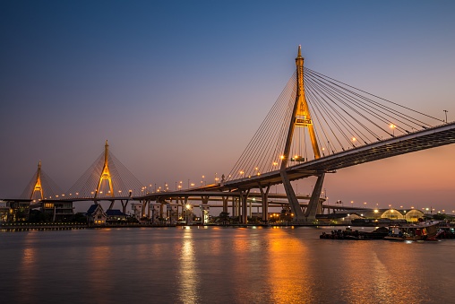 Bhumibol cable stayed bridge in beautiful twilight dusk evening, Bangkok Thailand. Transport and traffic concept.