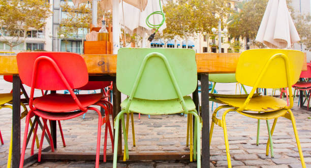 istock Sidewalk restaurant, multicolored chairs. Barcelona, Spain. 1618299386