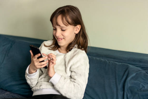 istock Girl using mobile phone at home 1618301643