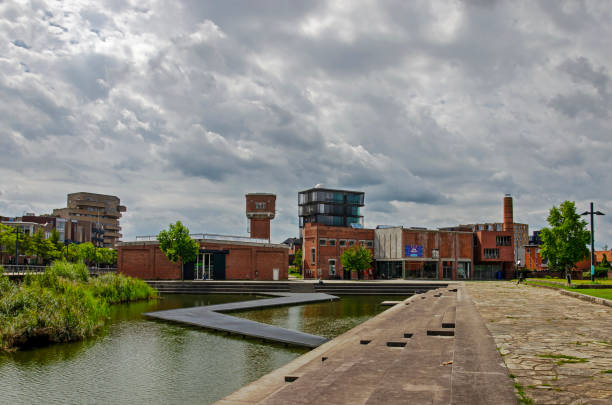 Enschede, The Netherlands, August 9, 2023: dramatic sky above Roombeek neighbourhood with converted textile factories and new buildings built after the fireworls disaster