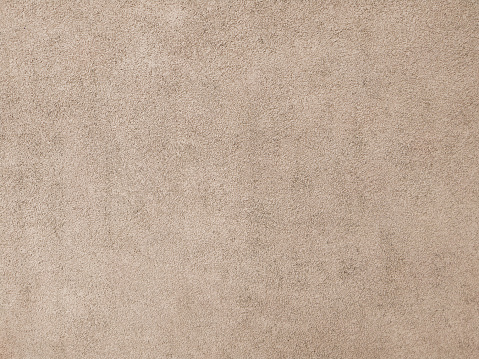Grunge concrete wall texture. Beige abstract background, an old plaster cement surface. Minimal urban photo. Easily add depth and organic texture to your designs.