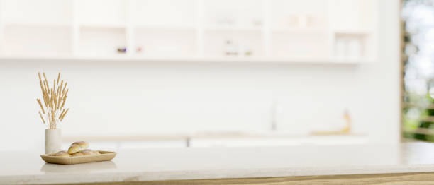 istock Copy space on a white tabletop over a blurred minimal white kitchen in the background. 1618311959