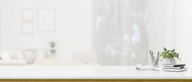 istock A modern white workspace with copy space over a blurred modern white living room in the background 1618312503