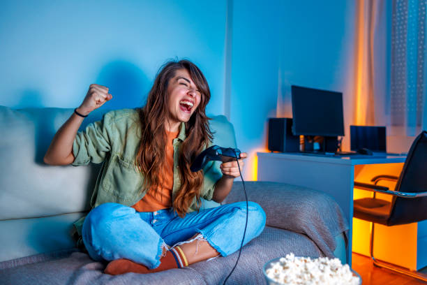 Woman having fun playing video games at home