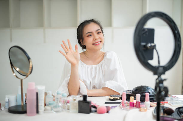 istock A happy Asian female beauty blogger speaking to the camera and recording her makeup tutorial video 1618315428