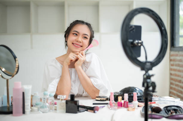 istock A cheerful Asian female beauty blogger recording her makeup tutorial video in her home studio. 1618315485
