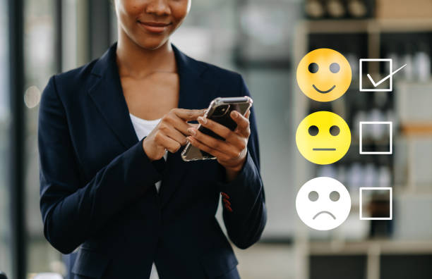 istock Customer service evaluation concept. woman Show face smile emoticon show on virtual screen from hand.looking at smart phone, tablet and laptop 1618325242