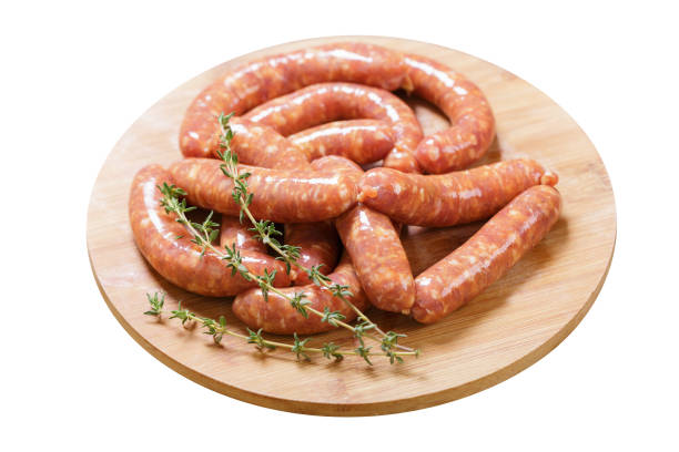 istock Fresh sausages on a board isolated on white background 1618331773