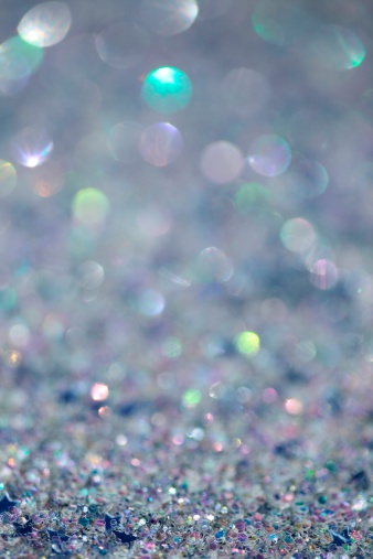XXXL photo - macro of silver iridescent glitter with very short depth of field to create a blurred sparkle background, with crisp focus texture towards bottom.  
